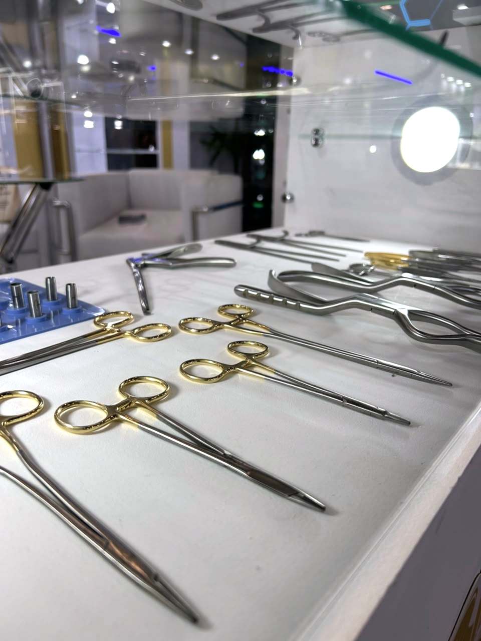 Porta-agulhas e pinças com argolas douradas em expositor da FATO.